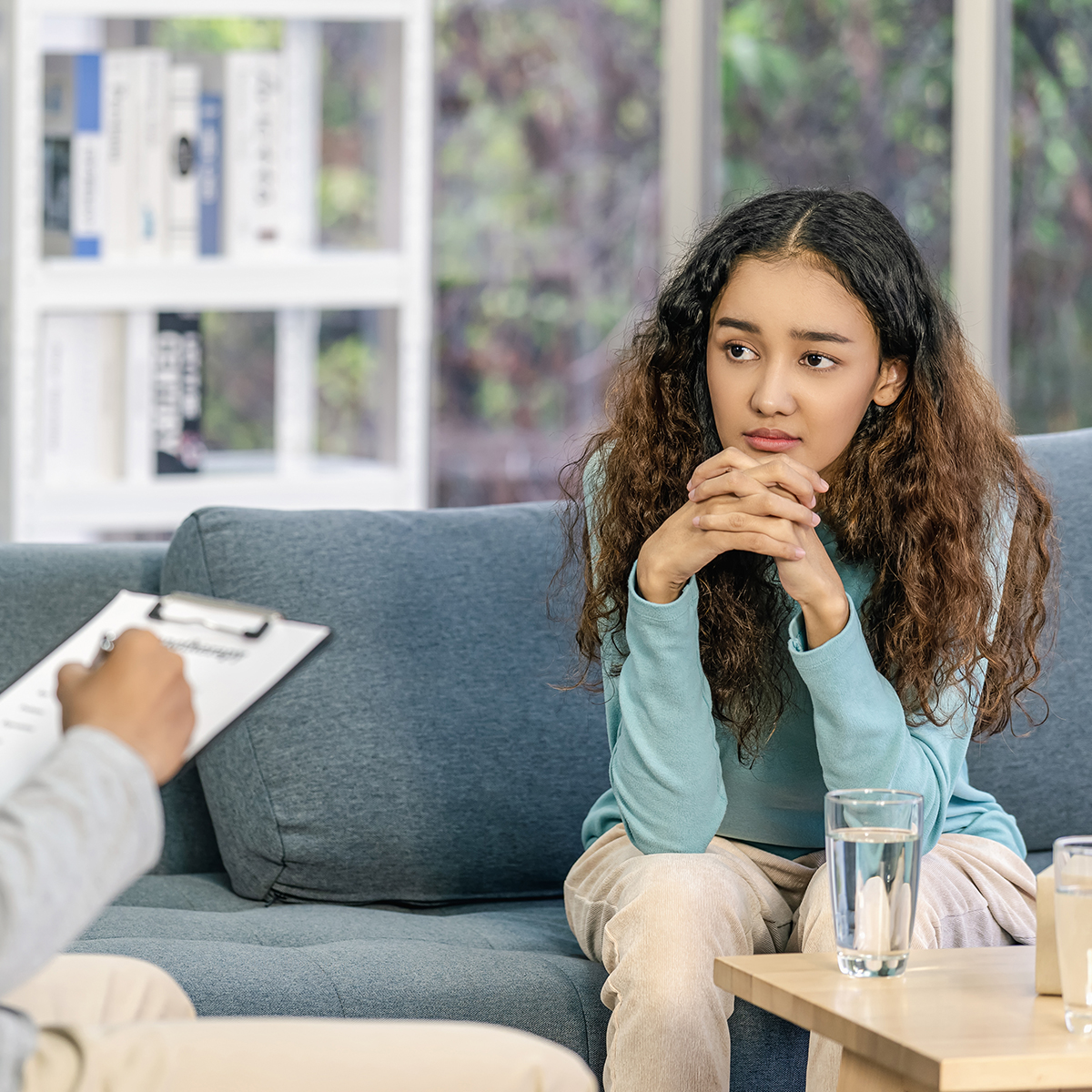 Teen in therapy Teen girl talking with therapist